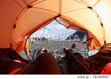 Two hikers enjoy the beautiful landscape in tent 78296680