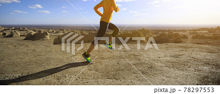 Fitness woman trail runner cross country running on sand desert 78297553
