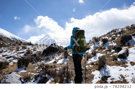 Woman backpacker hiking in winter high altitude mountains Woman backpacker hiking in winter high altitude mountains 78298212