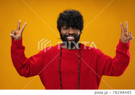 Portrait of smiling young black man in studio 78298485