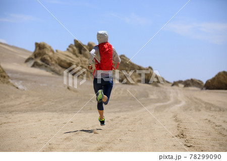 Fitness woman trail runner cross country running on sand desert 78299090