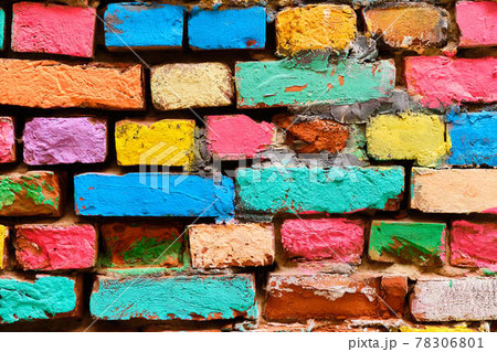 crumbling brick wall in different colors painted. 78306801