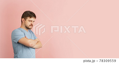 Flyer. Half-length portrait of young Caucasian man isolated on light pink background. 78309559