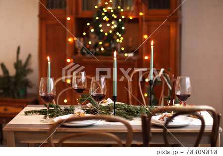 Candles and wine on Christmas table Candles and wine on Christmas table 78309818