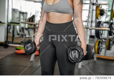 Asian sports woman in the gym, athletes training, workout lifting weight, plank and push up. tattoo Asian sports woman in the gym, athletes training, workout lifting weight, plank and push up. tattoo 78309874