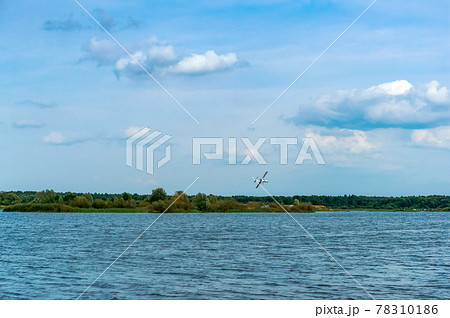Small aircraft over the river. Lake of the woods. A natural body of water in summer. 78310186