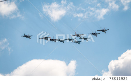 Moscow, Russia - May, 05, 2021: Fighters Su-35S and Su-30SM with bombers Su-34 in the blue sky over Red Square in the group Tactical Wing. Aviation part of Victory parade in Moscow Moscow, Russia - May, 05, 2021: Fighters Su-35S and Su-30SM with bombers Su-34 in the blue sky over Red Square in the group Tactical Wing. Aviation part of Victory parade in Moscow 78311925
