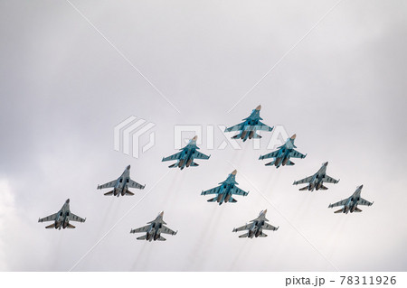 Moscow, Russia - May, 05, 2021: Fighters Su-35S and Su-30SM with bombers Su-34 in the blue sky over Red Square in the group Tactical Wing. Aviation part of Victory parade in Moscow 78311926