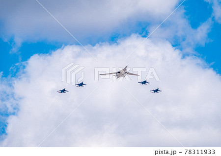 Moscow, Russia - May, 05, 2021: The Tu-160 strategic missile carrier, accompanied by four Su-35S fighter jets, flies over Red Square during the preparation of the May 9 parade. Moscow, Russia - May, 05, 2021: The Tu-160 strategic missile carrier, accompanied by four Su-35S fighter jets, flies over Red Square during the preparation of the May 9 parade. 78311933
