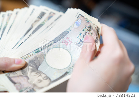 大量の1万円札を手に持っている写真。お金持ちのイメージ。 大量の1万円札を手に持っている写真。お金持ちのイメージ。 78314523