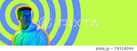 Young happy smiling looking away isolated over bright yellow abstract background in neon light. Concept of beauty, fashion,ad. Flyer Young happy smiling looking away isolated over bright yellow abstract background in neon light. Concept of beauty, fashion,ad. Flyer 78318094