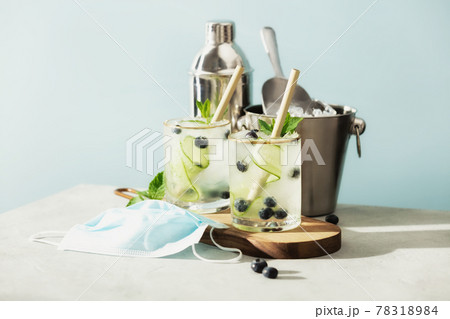 Summer cocktails and medical mask on blue sky background. . Bar, cafe, restaurants reopen after coronavirus. Quarantine is over concept 78318984