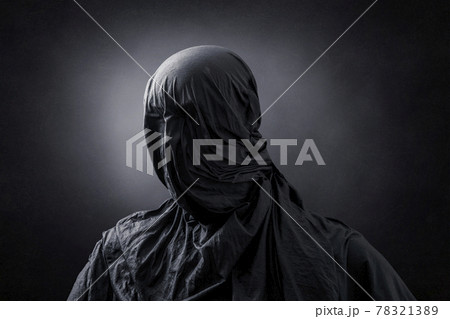 Creepy figure over dark misty background 78321389