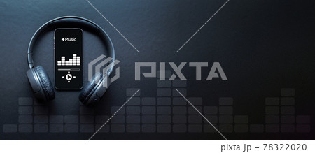 Music banner. Mobile smartphone screen with music application, sound headphones. Audio voice with radio beats on black background. Broadcast media music banner with copy space. 78322020