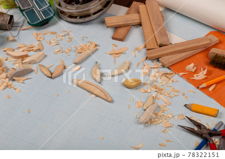 Handmade wooden fishing tacles graph paper background with tools and blanks. Handmade wooden fishing tacles graph paper background with tools and blanks. 78322151
