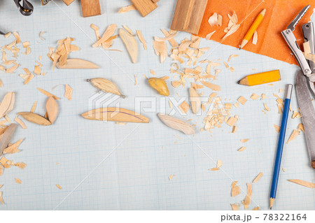 Handmade wooden fishing tacles graph paper background with tools and blanks. Handmade wooden fishing tacles graph paper background with tools and blanks. 78322164