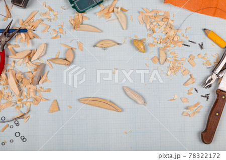 Handmade wooden fishing tacles graph paper background with tools and blanks. Handmade wooden fishing tacles graph paper background with tools and blanks. 78322172