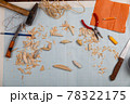 Handmade wooden fishing tacles graph paper background with tools and blanks. 78322175