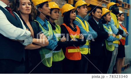 Large group of factory worker standing together in warehouse or storehouse 78323340