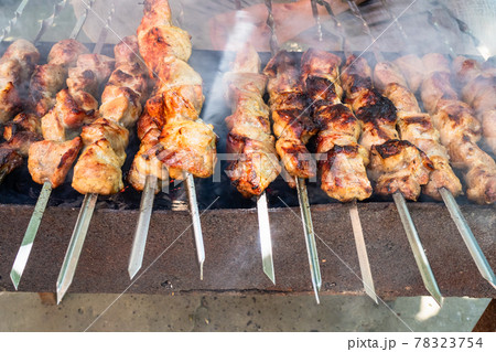 man cooks pork shish kebabs outdoors man cooks pork shish kebabs outdoors 78323754