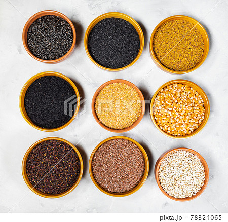 top view of various oilseeds in ceramic bowls 78324065