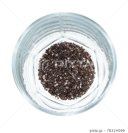 handful of dry chia seeds at bottom of glass handful of dry chia seeds at bottom of glass 78324099