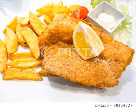 Chicken Milanese schnitzel with fried potatoes Chicken Milanese schnitzel with fried potatoes 78324527