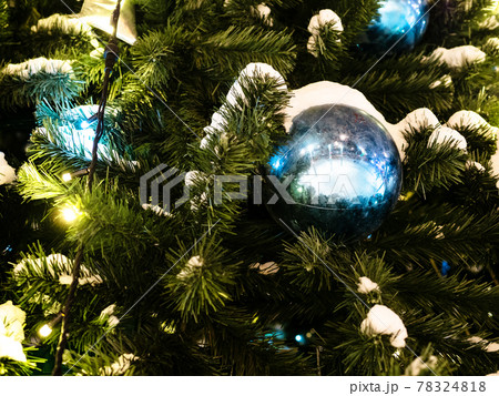 snow and ball on decorated Christmas tree close up 78324818