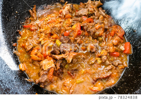 pottage from lamb and vegetables in iron cauldron 78324838