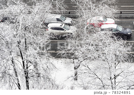 cars driving on wet city road on winter day 78324891