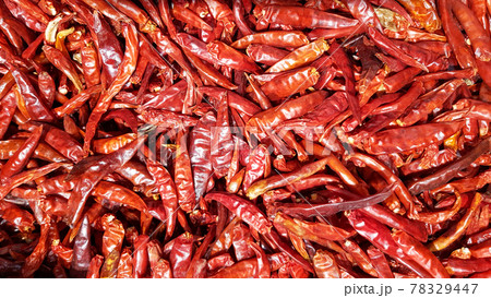 A large number of dried red peppers are used as a background..Dried red peppers at a local market 78329447