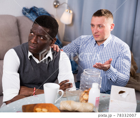 Unhappy male after conflict, friend tries reconcile 78332007