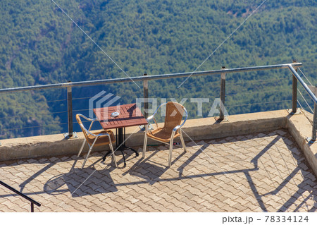 Table and chairs on a viewing platform for rest on a top of Tahtali mountain near Kemer, Antalya province in Turkey 78334124