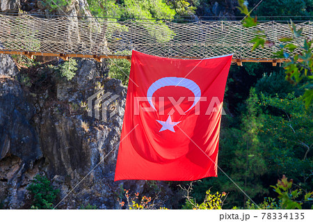 Turkish flag hanging from suspension wooden bridge in Goynuk canyon in Antalya province, Turkey Turkish flag hanging from suspension wooden bridge in Goynuk canyon in Antalya province, Turkey 78334135