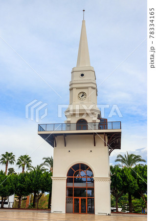 White clock tower in the center of Kemer, Antalya province, Turkey 78334165