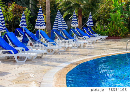 Chaise longues near a swimming pool. Concept of spa, rest, relaxation, holidays, resort 78334168
