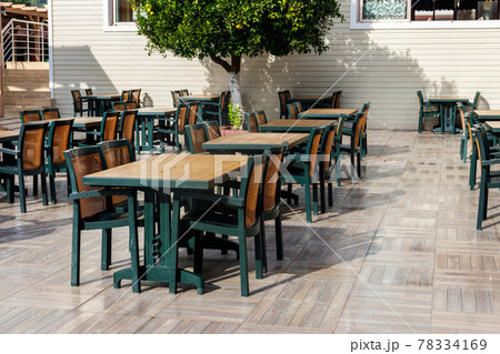 Chairs and tables in cozy outdoor cafe at summer 78334169
