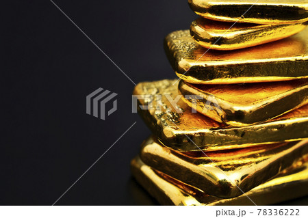 Close up photo a gold bar on black background, copy space 78336222