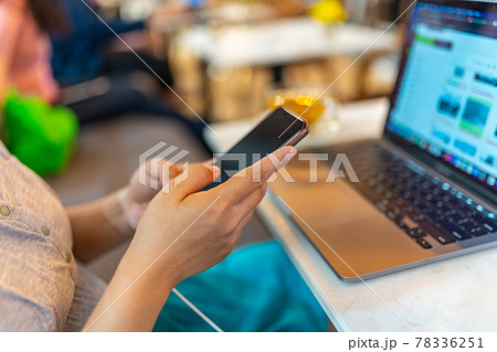 Selective focus of pregnant woman using smartphone while charging battery  78336251