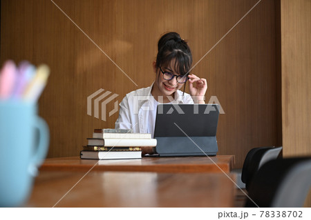 Asian woman designer working with computer tablet in modern office. Asian woman designer working with computer tablet in modern office. 78338702