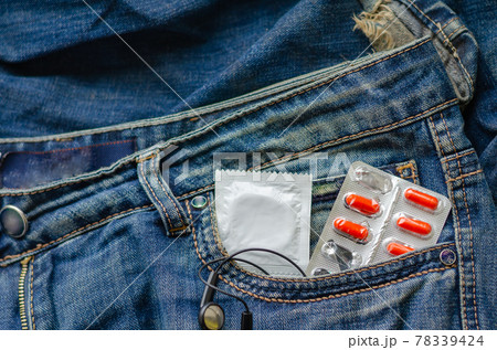 Medical pills for sexual health and one condom in your jeans pocket. 78339424