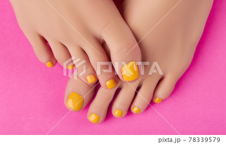 Womans feet with spring summer nail design on pink background. Body treatment Womans feet with spring summer nail design on pink background. Body treatment 78339579