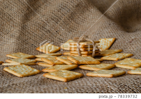 Salted crackers on burlap background. 78339732