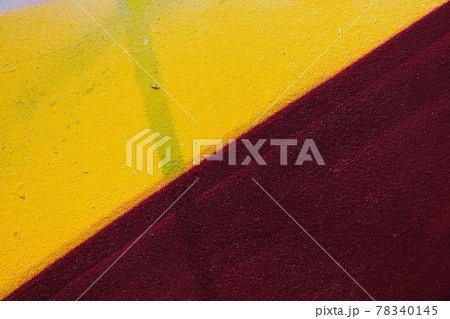 Stucco texture with yellow and burgundy paint. 78340145