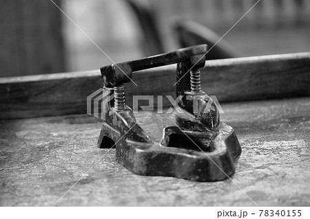 Old hole punch on the table. Black and white photography. Noise. 78340155