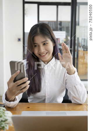 Happy young woman having video call on her smart phone. 78340500