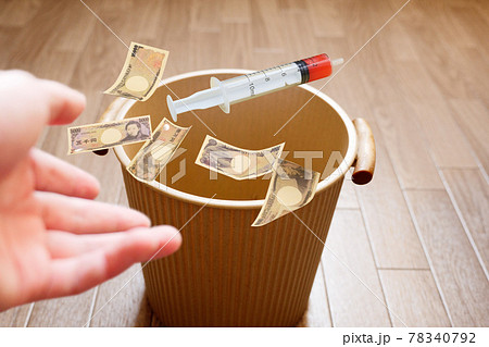 使用期限が切れて破棄されるワクチンのイメージでお金とともにゴミ箱へ投げ捨てる 78340792