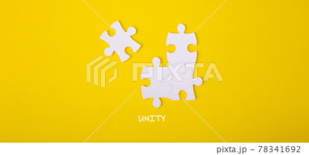 Four puzzle pieces connected to each other with the word unity. 78341692
