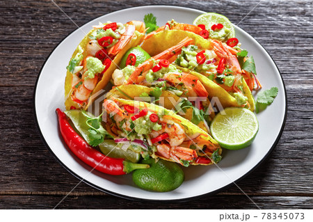 taco shells with shrimps on a plate 78345073
