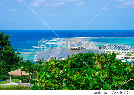 沖縄の青い空と青い海、海洋博公園の総合案内所（ハイハイプラザ）から美ら海水族館の銀屋根 78346735